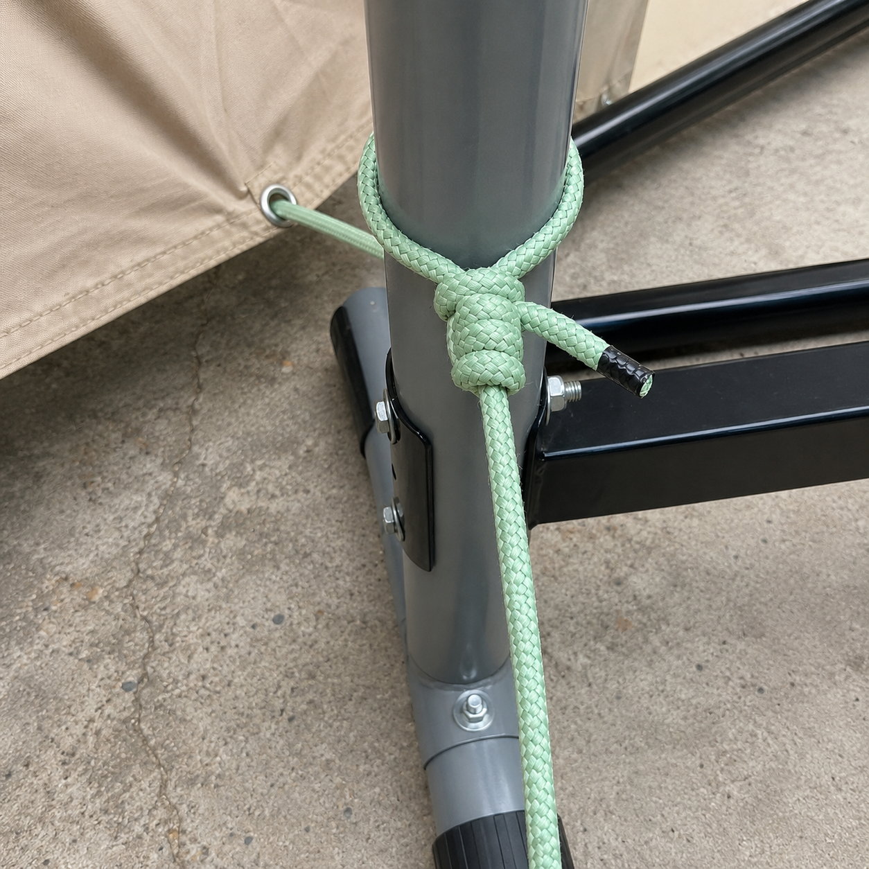 Green rope knotted around a metal structure